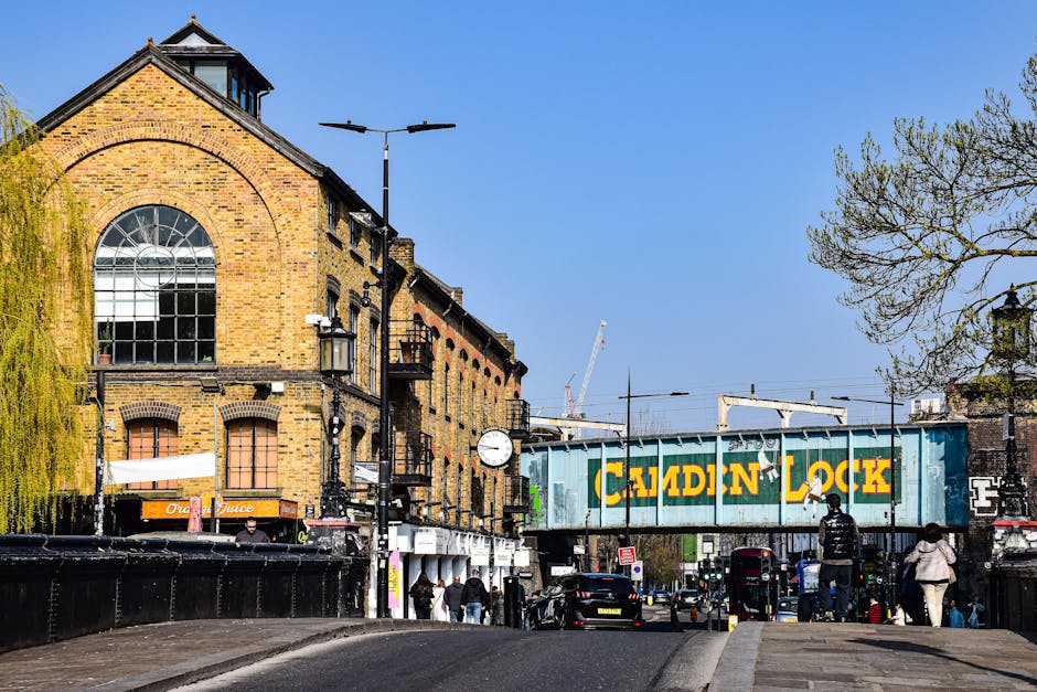 A street scene in Waterloo featuring a mix of historic and modern buildings with brick and ornate facades, several multi-story structures with large windows, and a street-level view with a street clea